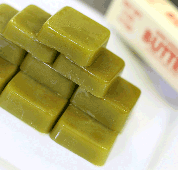 Cubes of cannabis butter made with already vaped bud stacked on a table
